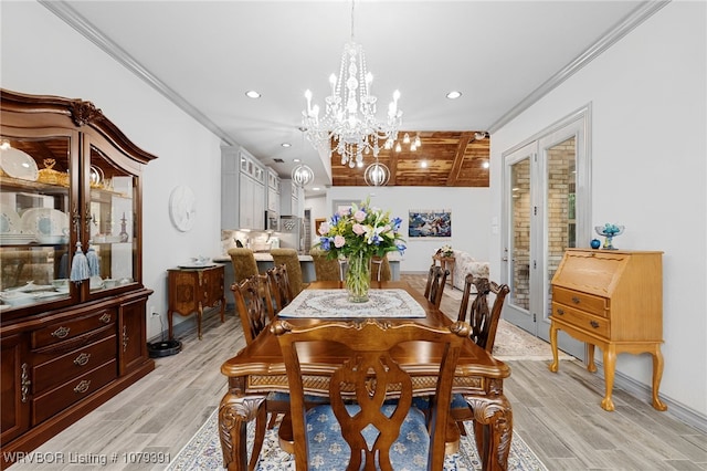 dining space featuring baseboards, a chandelier, ornamental molding, recessed lighting, and light wood-style floors