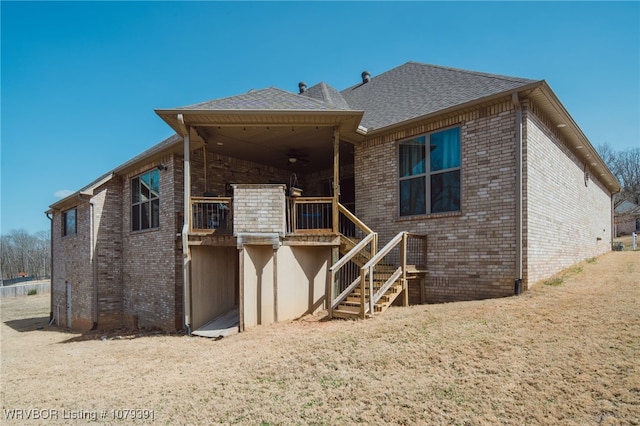 rear view of property featuring stairway and brick siding