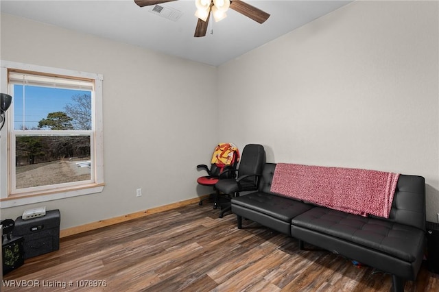 living area featuring a ceiling fan, wood finished floors, visible vents, and baseboards