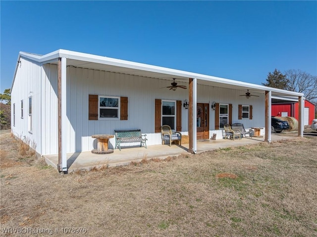 back of property featuring a yard, a patio, and a ceiling fan