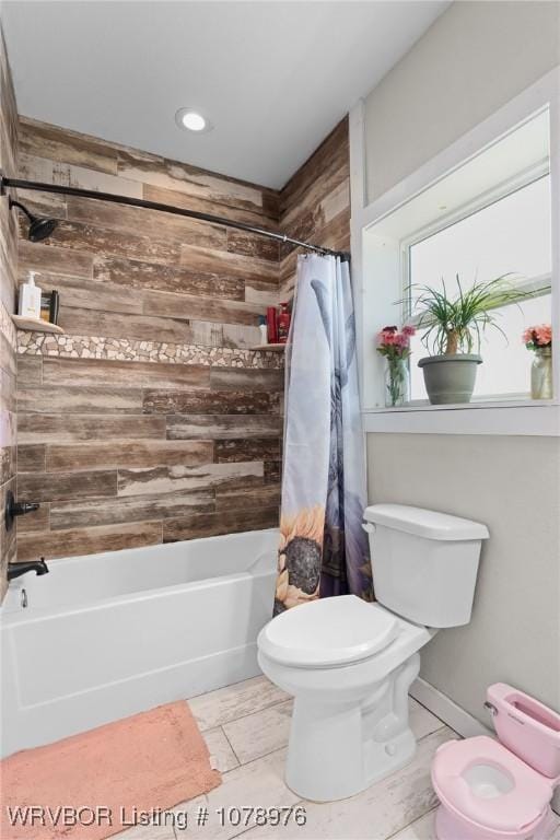 bathroom with toilet and shower / bath combo with shower curtain