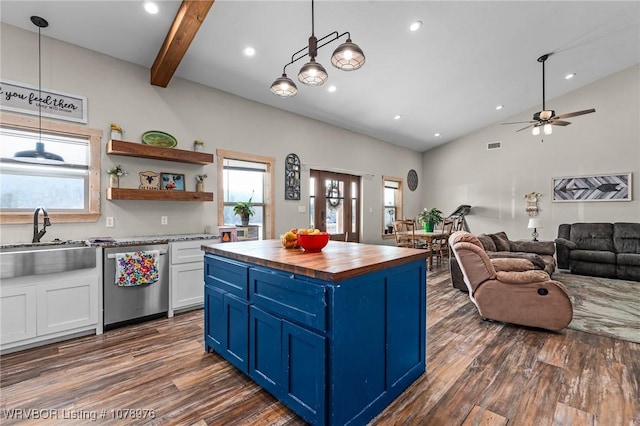 kitchen featuring blue cabinets, a sink, stainless steel dishwasher, butcher block counters, and dark wood-style flooring