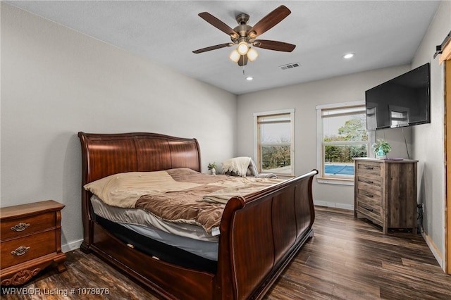 bedroom featuring a ceiling fan, baseboards, visible vents, dark wood finished floors, and recessed lighting