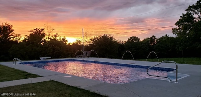 pool at dusk with a patio