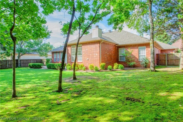 2112 Rannoch Trce, Fort Smith, AR 72908 - rear view of house with brick siding, a chimney, and a shingled roof