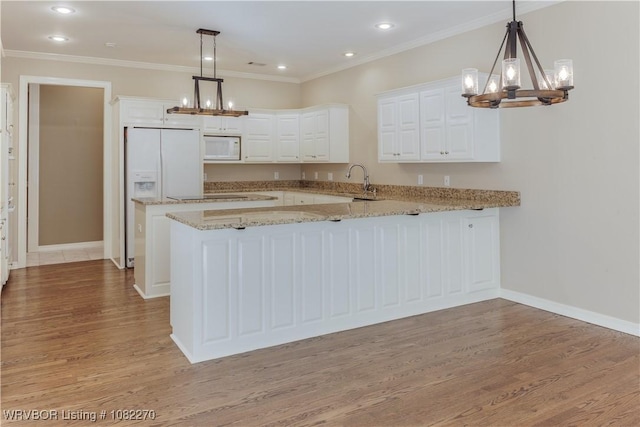 2112 Rannoch Trce, Fort Smith, AR 72908 - kitchen featuring a chandelier, white appliances, light wood finished floors, a peninsula, and white cabinets