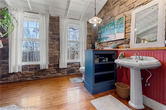 bar featuring hardwood / wood-style floors, a wealth of natural light, wood ceiling, and vaulted ceiling with beams