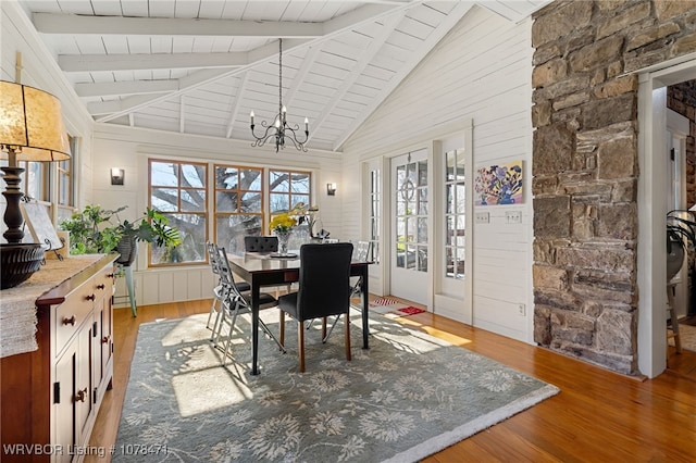 dining area featuring wooden ceiling, vaulted ceiling with beams, a chandelier, and hardwood / wood-style floors