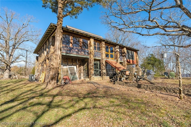 rear view of property featuring a yard