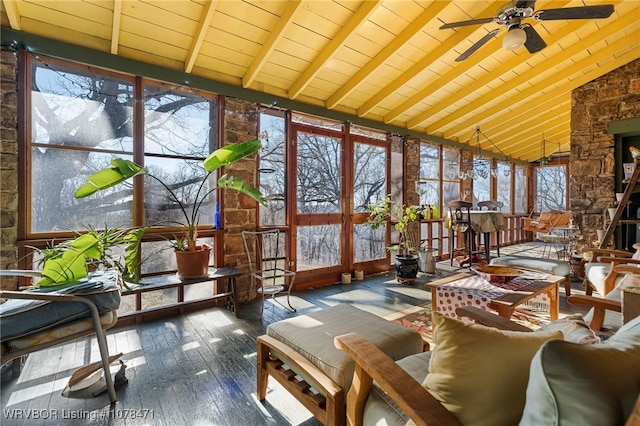 sunroom featuring ceiling fan and vaulted ceiling with beams