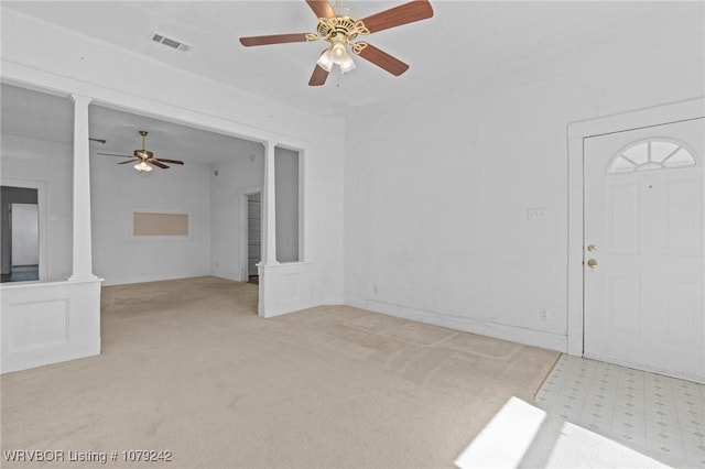 unfurnished living room featuring a ceiling fan, visible vents, light carpet, and ornate columns