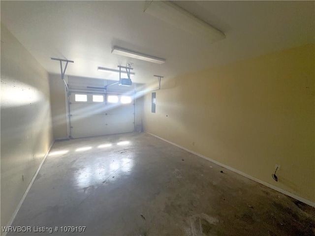 garage with baseboards, a garage door opener, and electric panel