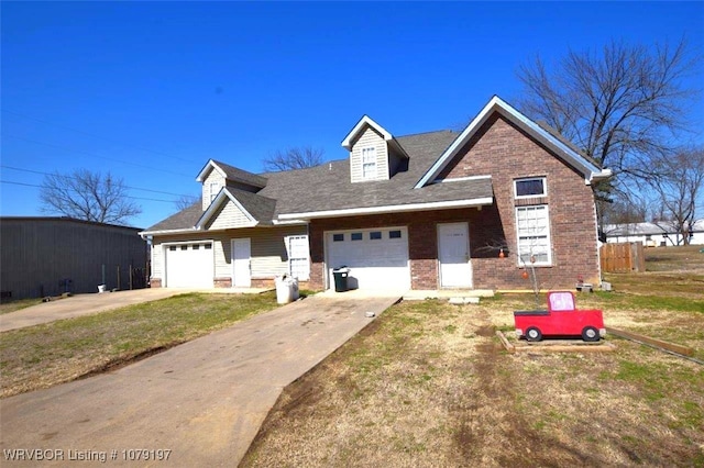 view of front of house with concrete driveway, a front yard, and brick siding