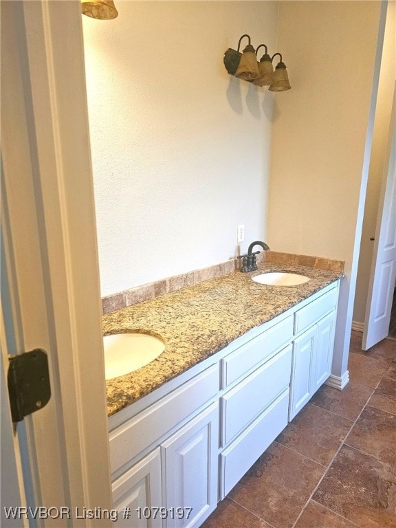 bathroom with double vanity and a sink