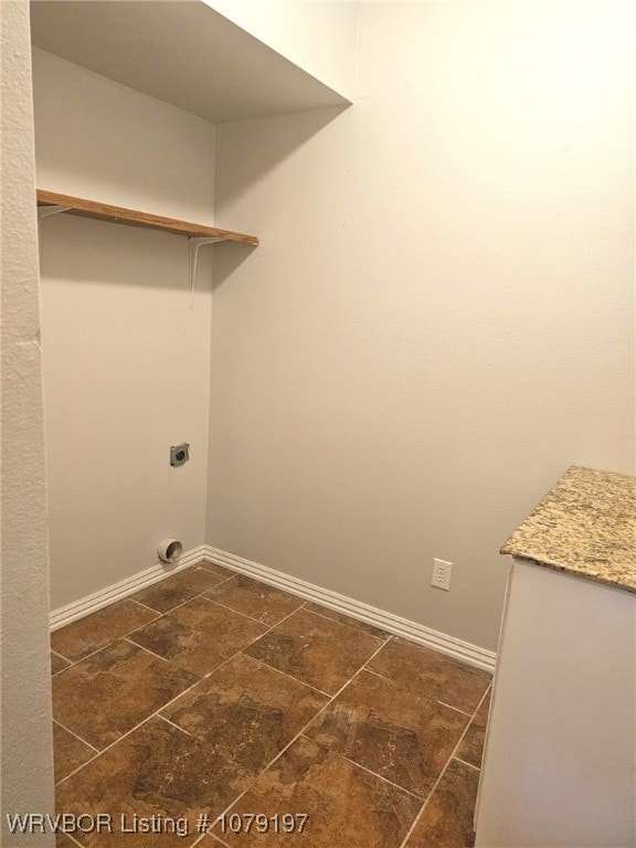 laundry room featuring baseboards, laundry area, and electric dryer hookup