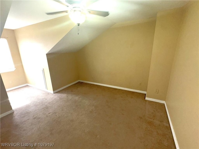 additional living space featuring baseboards, carpet flooring, ceiling fan, and vaulted ceiling