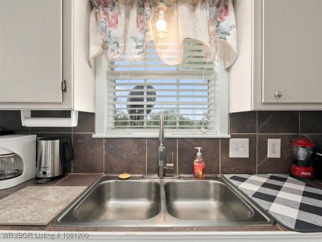 42735 Timber Ridge Rd, Howe, OK 74940 - kitchen view of a sink, white cabinetry, and tasteful backsplash