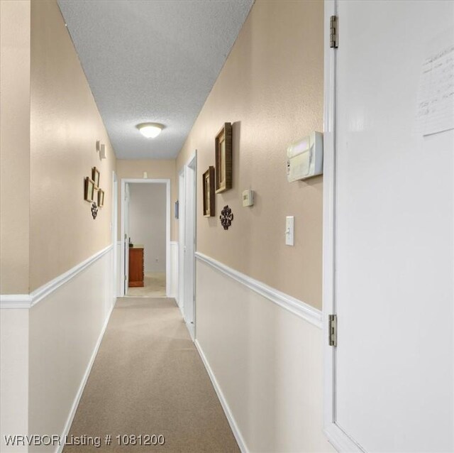42735 Timber Ridge Rd, Howe, OK 74940 - hall with a textured ceiling, light carpet, and baseboards