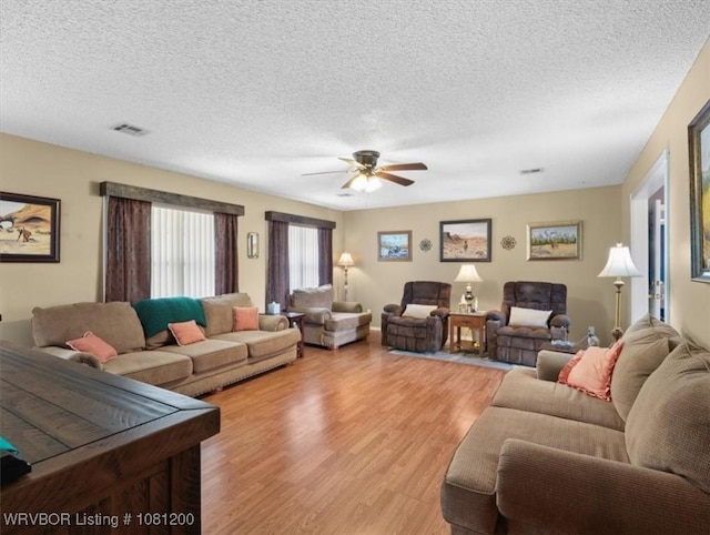 42735 Timber Ridge Rd, Howe, OK 74940 - living room with light wood-type flooring, a ceiling fan, and a textured ceiling