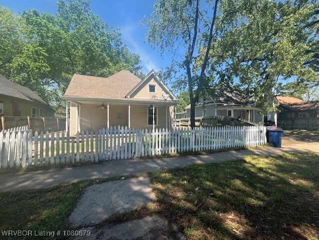 411 N 21st St, Fort Smith, AR 72901 - farmhouse inspired home featuring covered porch and a fenced front yard