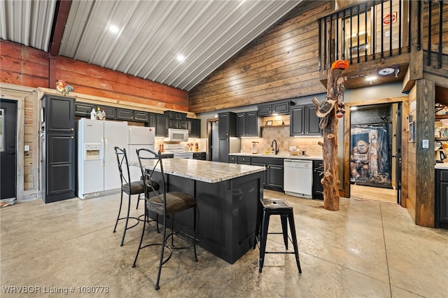 465 Boyd Dr, New Blaine, AR 72851 - kitchen featuring white appliances, finished concrete flooring, high vaulted ceiling, a sink, and a breakfast bar