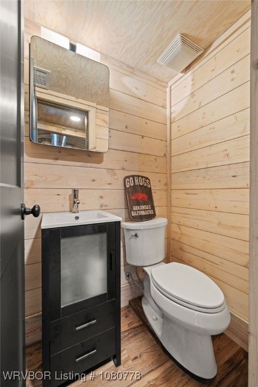 465 Boyd Dr, New Blaine, AR 72851 - half bath featuring wood finished floors, toilet, wood walls, and vanity