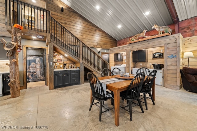 465 Boyd Dr, New Blaine, AR 72851 - dining room featuring high vaulted ceiling, wood walls, concrete flooring, stairway, and recessed lighting