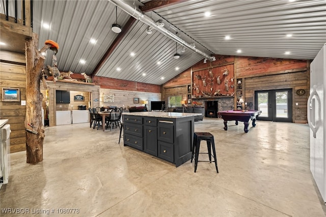 465 Boyd Dr, New Blaine, AR 72851 - kitchen featuring wood walls, finished concrete floors, billiards table, vaulted ceiling, and a kitchen breakfast bar