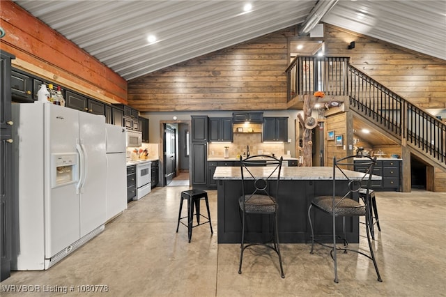 465 Boyd Dr, New Blaine, AR 72851 - kitchen with white appliances, concrete floors, vaulted ceiling, a breakfast bar, and decorative backsplash