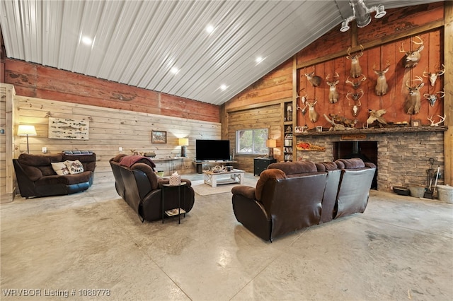 465 Boyd Dr, New Blaine, AR 72851 - living room featuring vaulted ceiling, wooden walls, concrete flooring, and a fireplace