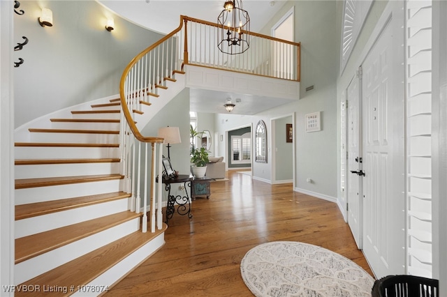 foyer featuring hardwood / wood-style floors and an inviting chandelier