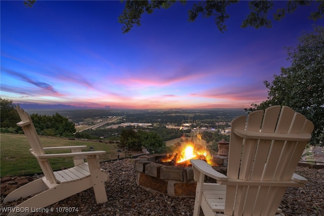 patio terrace at dusk featuring an outdoor fire pit