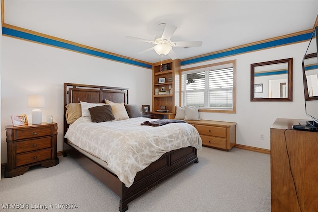 bedroom featuring light carpet, ceiling fan, and crown molding