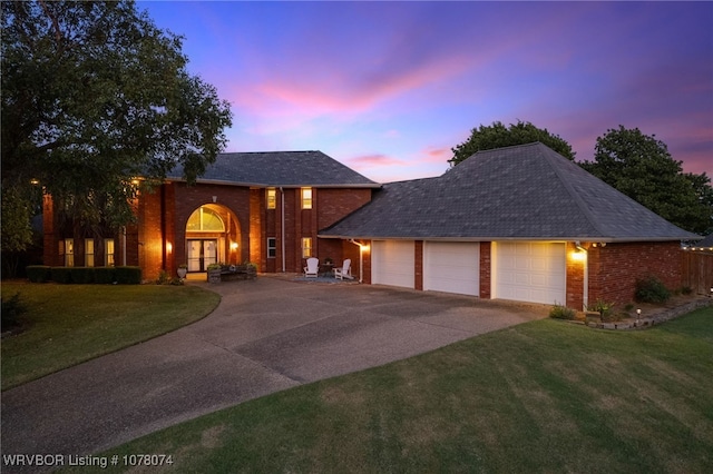 view of front of home featuring a garage and a yard