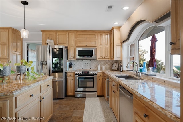 kitchen featuring sink, decorative backsplash, light stone countertops, decorative light fixtures, and stainless steel appliances