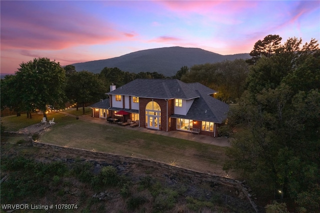 view of front facade with a mountain view and a yard