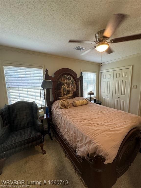 2925 Gary St Unit 12, Fort Smith, AR 72901 - bedroom with visible vents, ornamental molding, carpet floors, a closet, and a textured ceiling
