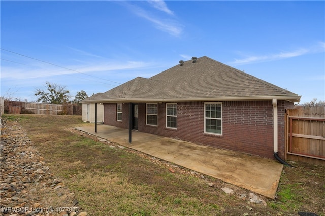 rear view of house with a yard and a patio area