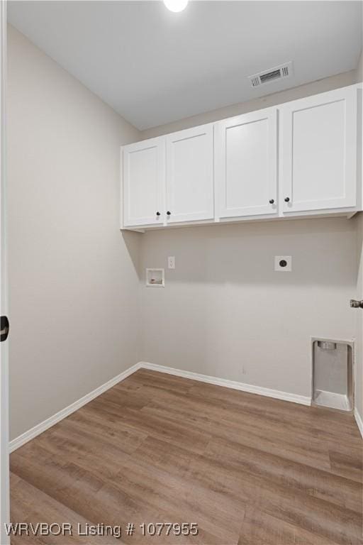 laundry area with cabinets, washer hookup, light hardwood / wood-style floors, and electric dryer hookup