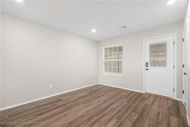 unfurnished room featuring hardwood / wood-style flooring and plenty of natural light