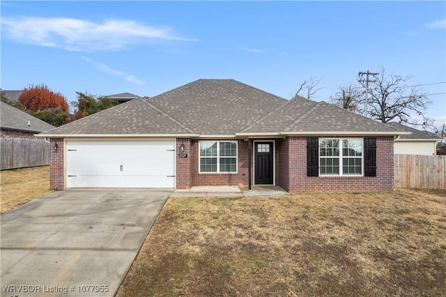 ranch-style home featuring a garage and a front lawn