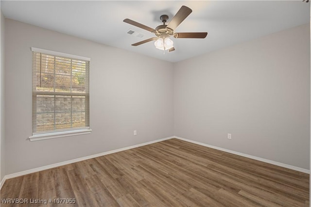 spare room featuring hardwood / wood-style floors and ceiling fan