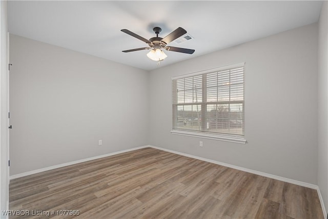 unfurnished room with wood-type flooring and ceiling fan