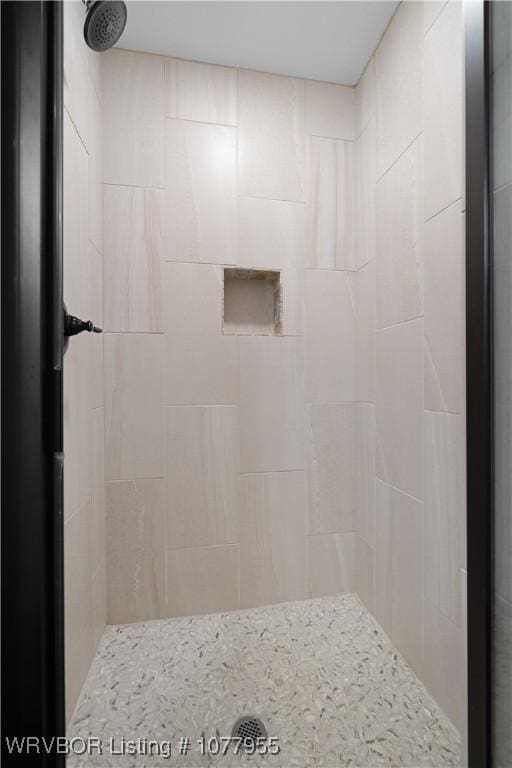 bathroom with a tile shower