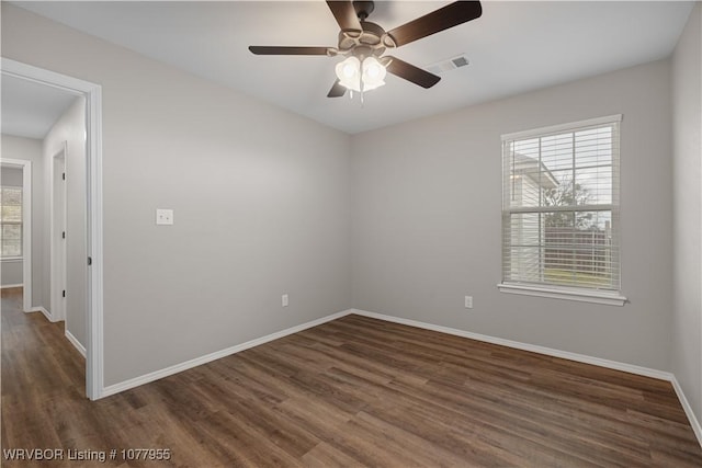 unfurnished room with ceiling fan and dark wood-type flooring