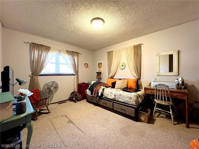 bedroom with carpet floors and a textured ceiling