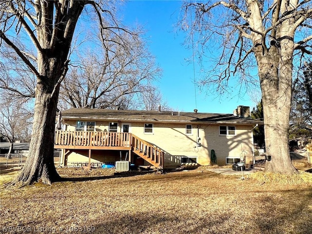 rear view of house featuring a wooden deck