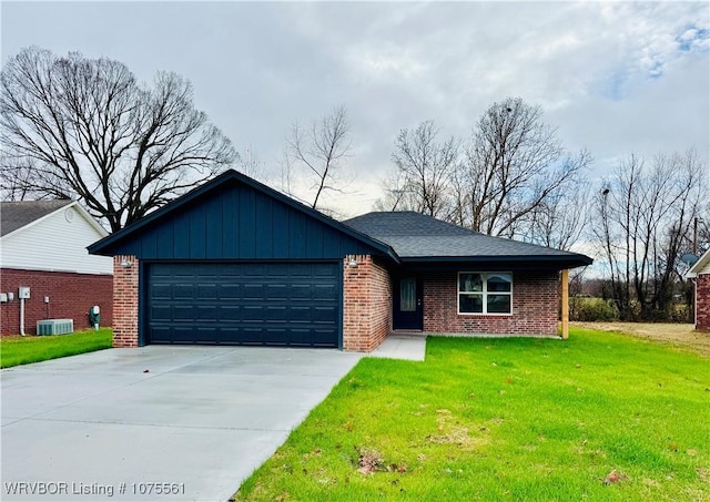 ranch-style house featuring cooling unit, a garage, and a front yard