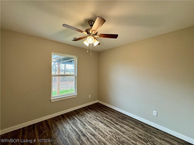 unfurnished room with ceiling fan and dark wood-type flooring