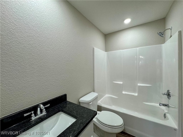 full bathroom with toilet, vanity, and tub / shower combination